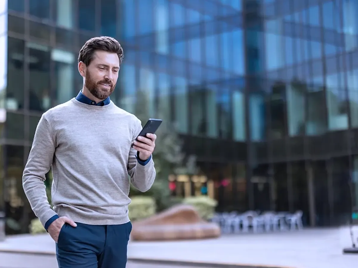 Professional taking a call on his mobile phone while walking outside